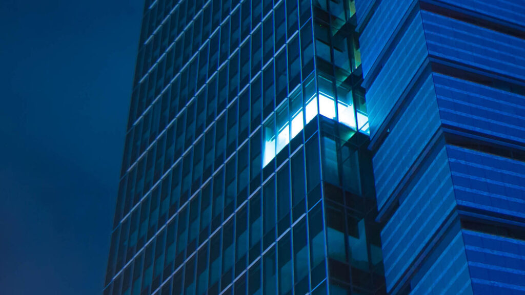 skyscraper with all but one office of lights off